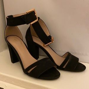 Kurt Geiger black sandals with gold hardware.